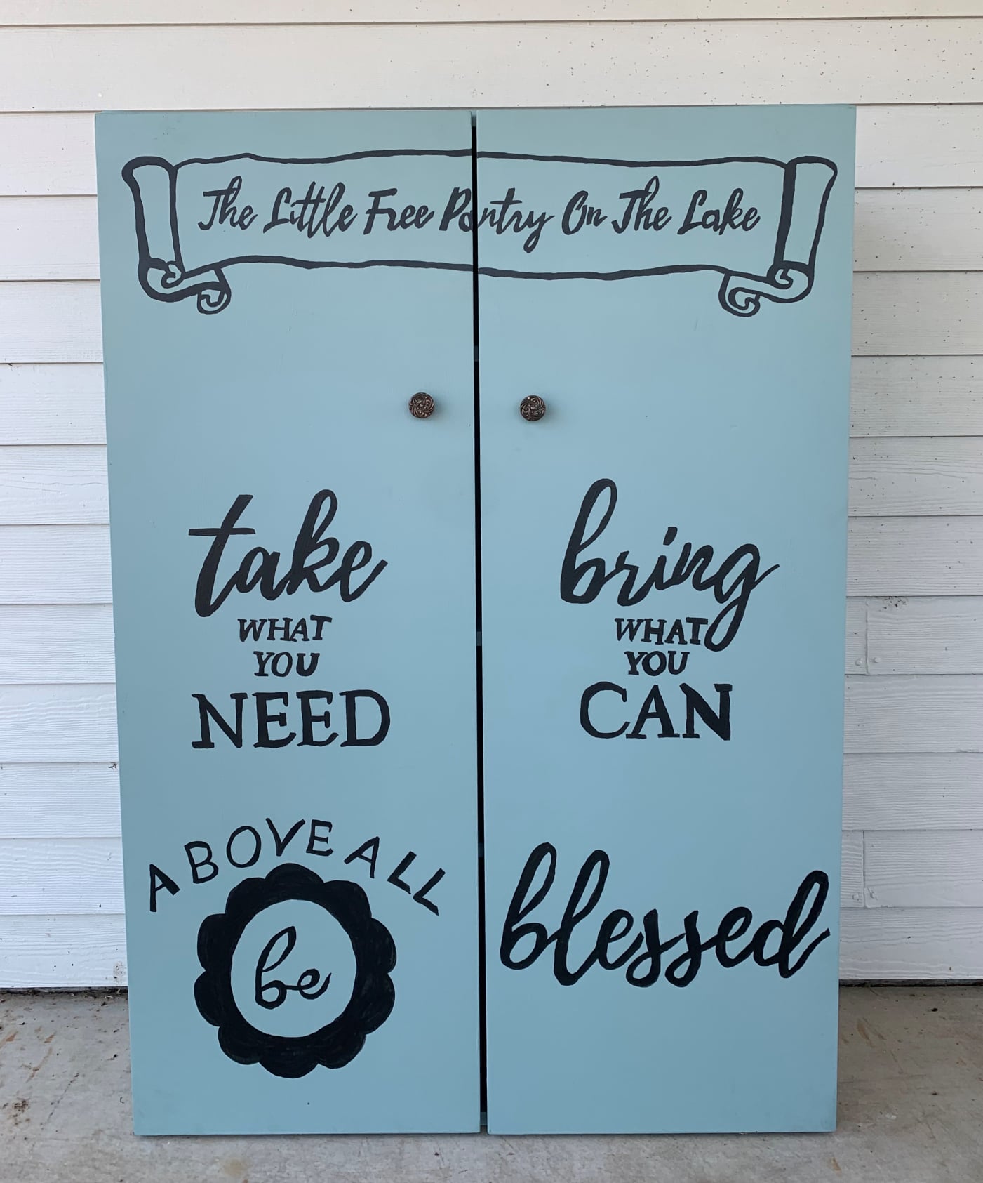 The Little Free Pantry On The Lake cabinet doors with hand-painted lettering